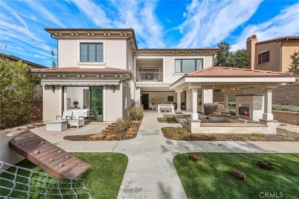 a view of a house with backyard porch and sitting area