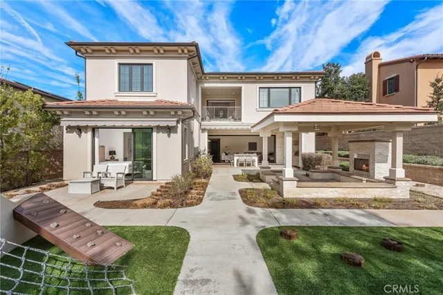 a view of a house with backyard porch and sitting area