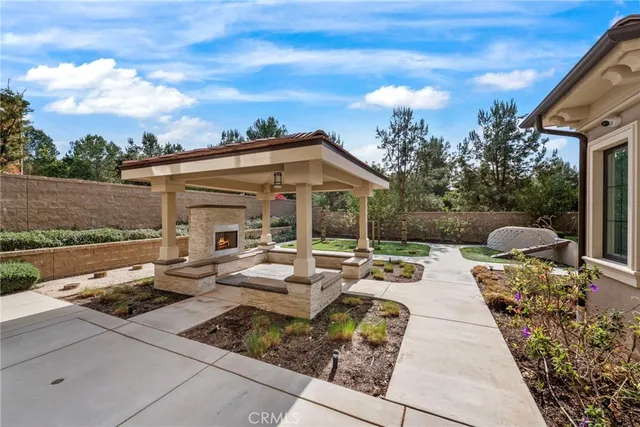 a view of a patio with couches table and chairs with wooden floor and fence