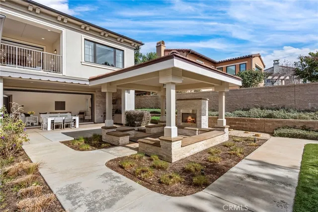a view of a house with backyard porch and sitting area