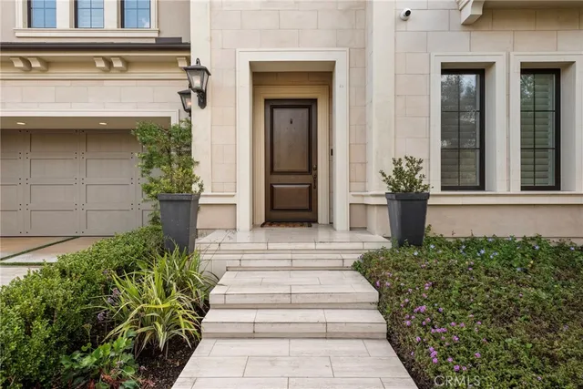 a front view of a house with potted plants