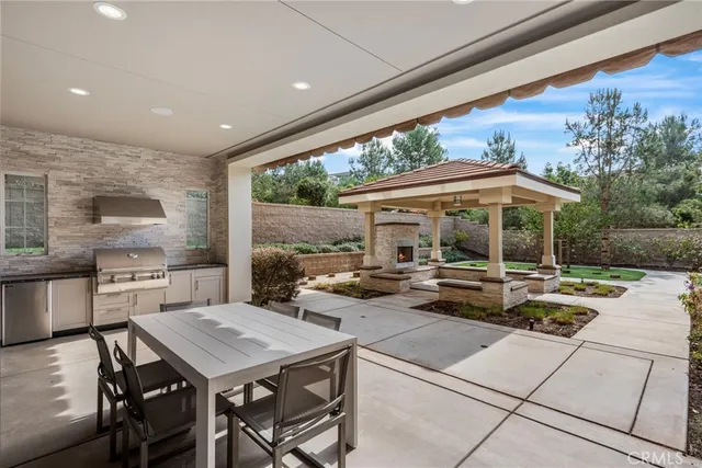 a view of a patio with a dining table and chairs