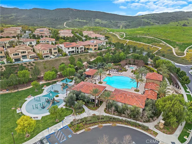 an aerial view of residential houses with outdoor space and river