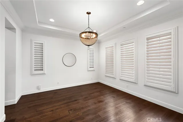 a view of a room with wooden floor and fan