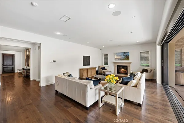 a living room with fireplace furniture and a wooden floor
