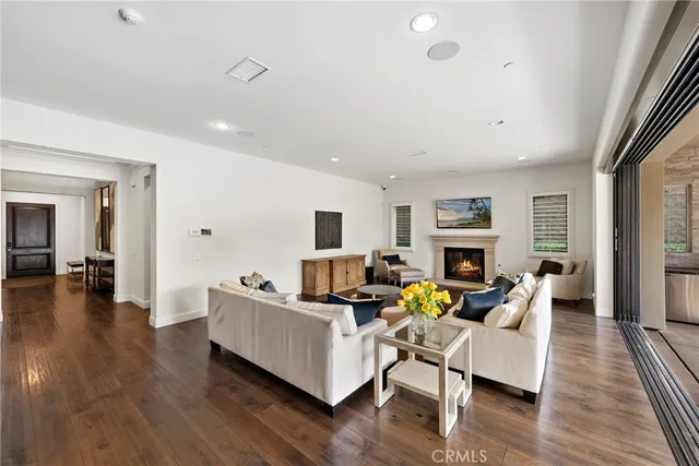 a living room with fireplace furniture and a wooden floor