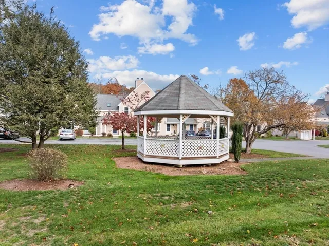 a living room with furniture a fireplace and a large mirror