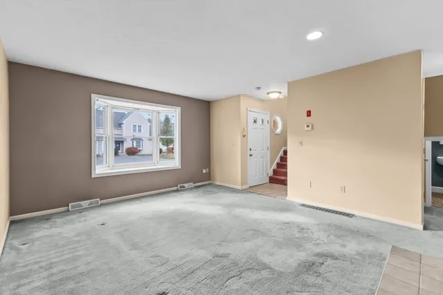 an empty room with a fireplace