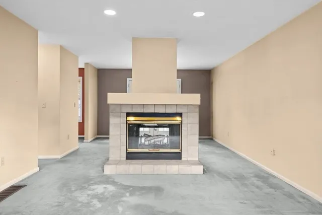 a dining room with furniture a fireplace and wooden floor