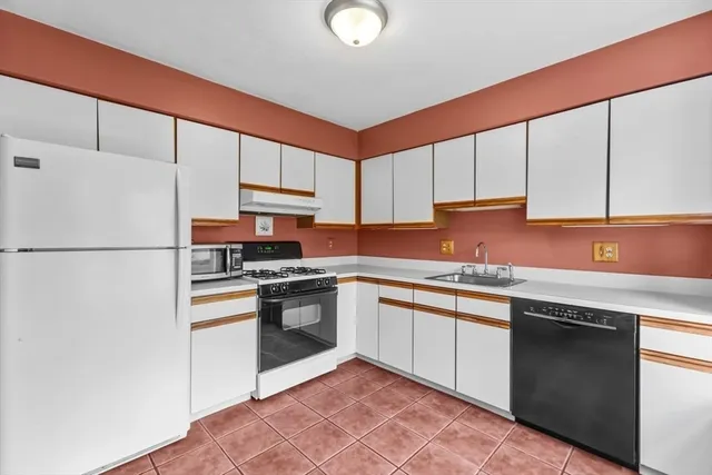 a kitchen with a stove a refrigerator and a stove