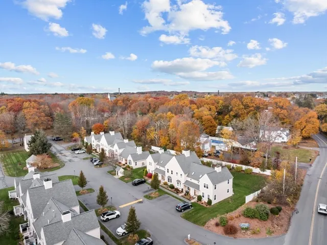 an aerial view of a house with a garden and lake view