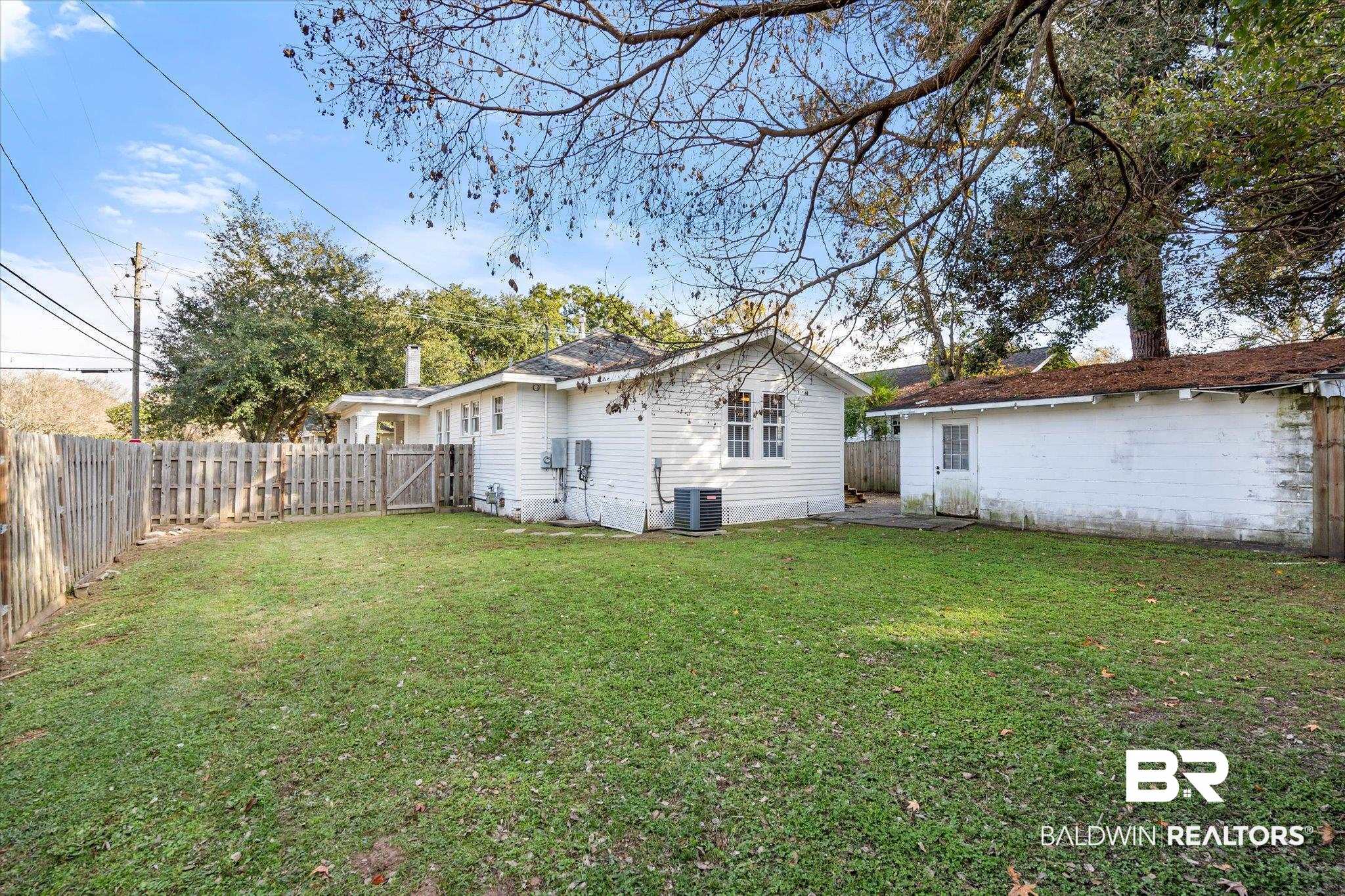 180 Williams Street Mobile, AL 36606 - Photo 18 of 20 Back of house featuring cooling unit and a yard