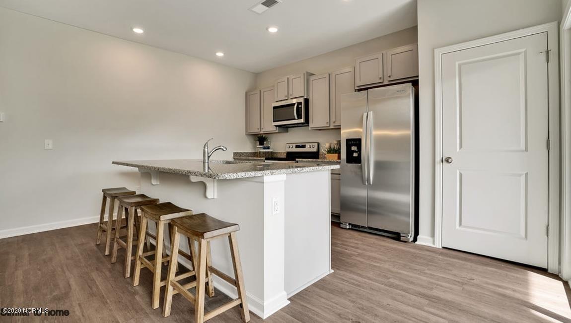 9067 St George Road, Unit LOT 34 Wilmington, NC 28411 - Photo 8 of 57 The large kitchen island has room to prepare food and while friends and family have a place to chill.