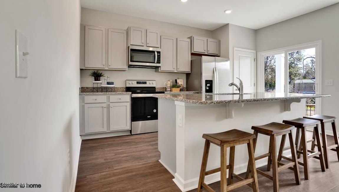 9067 St George Road, Unit LOT 34 Wilmington, NC 28411 - Photo 6 of 57 The large kitchen island has room to prepare food and while friends and family have a place to chill.
