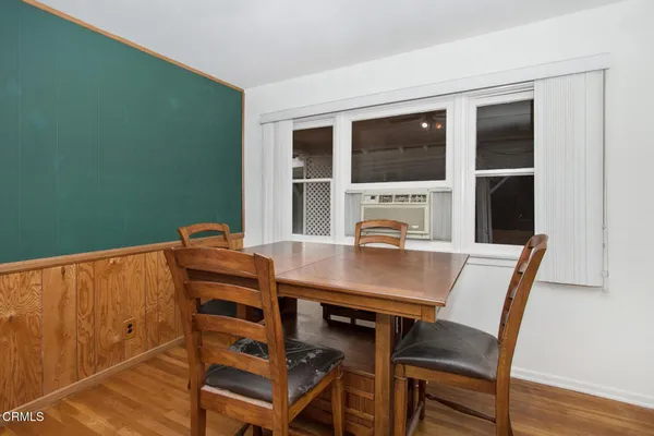 a view of a dining room with furniture and window