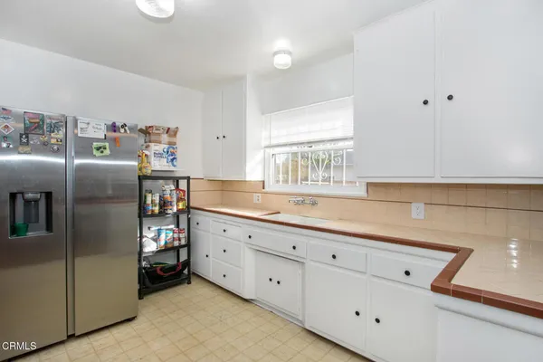 a kitchen with stainless steel appliances a refrigerator sink and cabinets