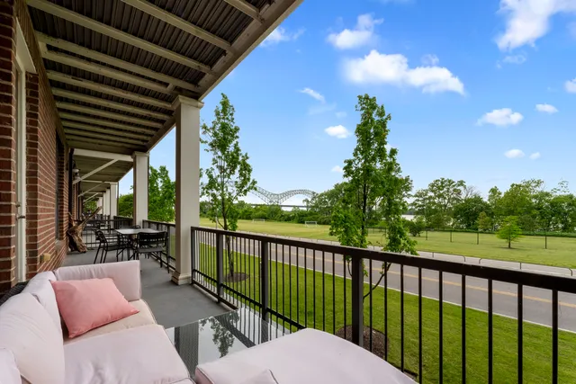 a view of swimming pool with outdoor seating and lake