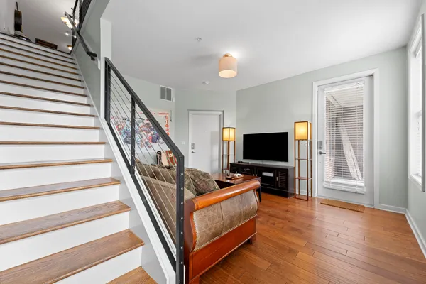 a view of a hallway with wooden floor