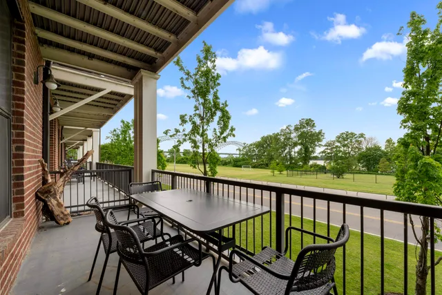 a view of a porch with furniture and a yard