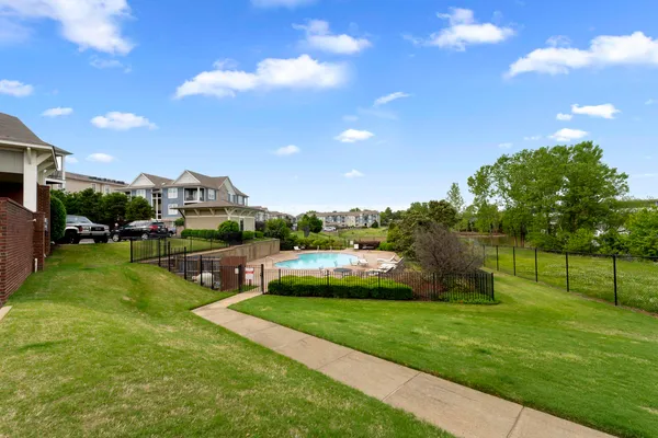 a view of a porch with furniture and a yard