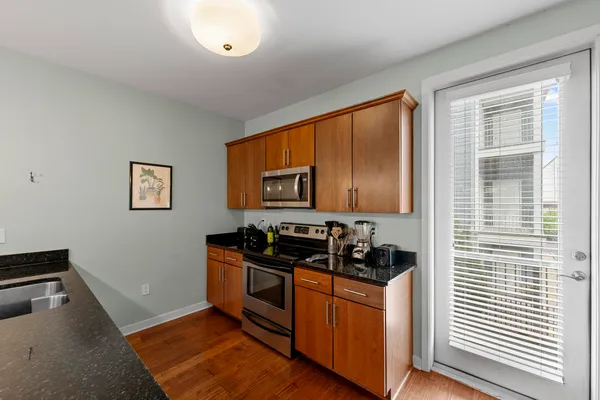 a kitchen with stainless steel appliances granite countertop a refrigerator and a stove top oven