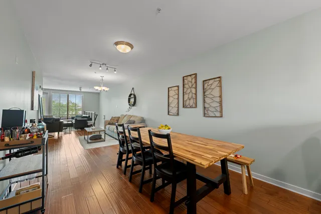 a living room with furniture a rug and a floor to ceiling window