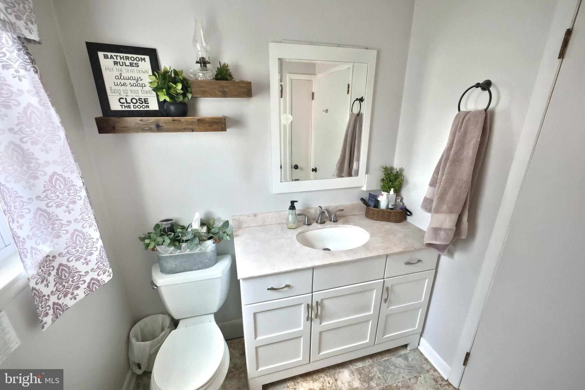 798 Goram Road Brogue, PA 17309 - Photo 36 of 57 a bathroom with a granite countertop sink toilet and a mirror