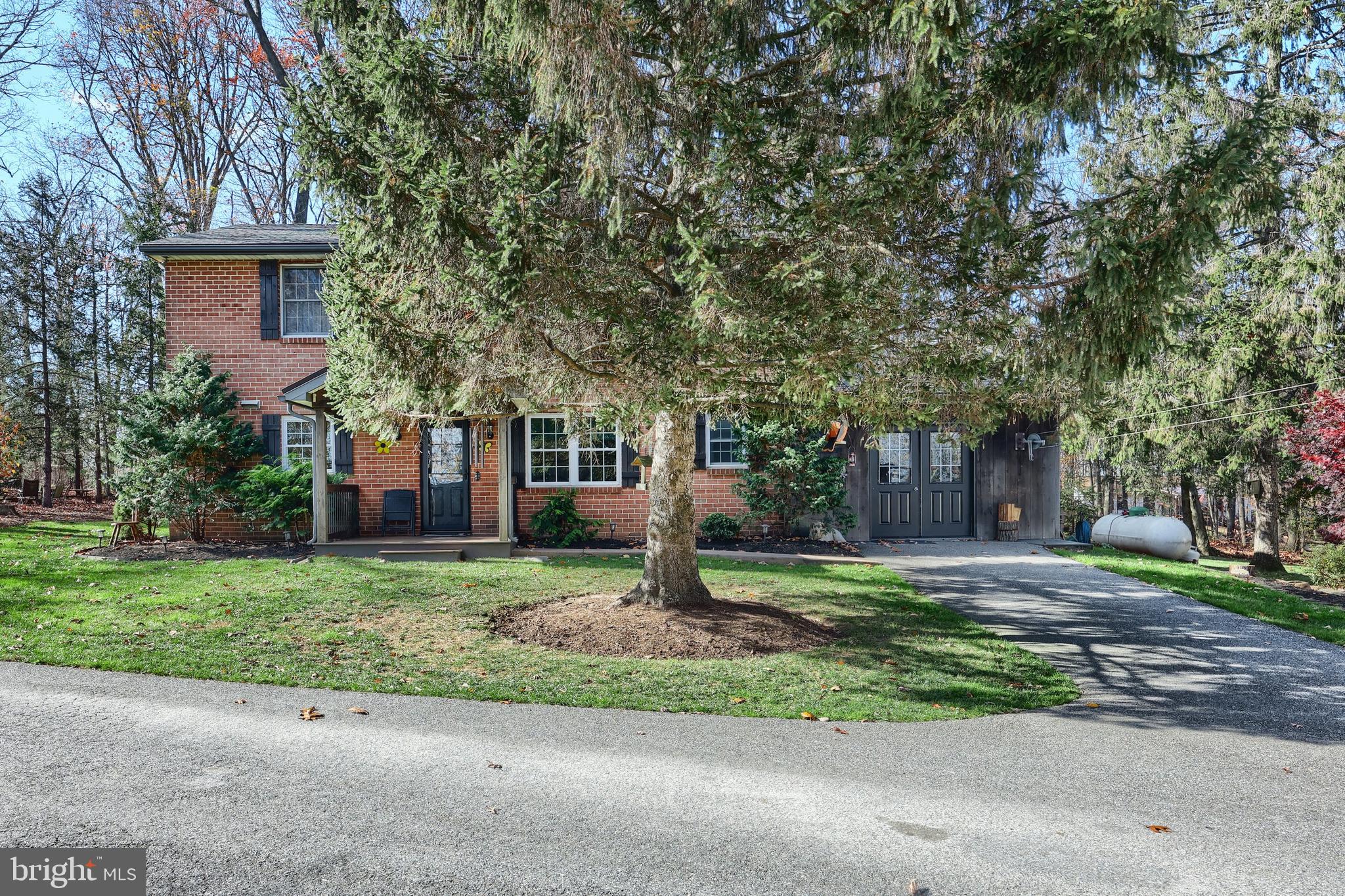 798 Goram Road Brogue, PA 17309 - Photo 4 of 57 a front view of a house with a yard and garage
