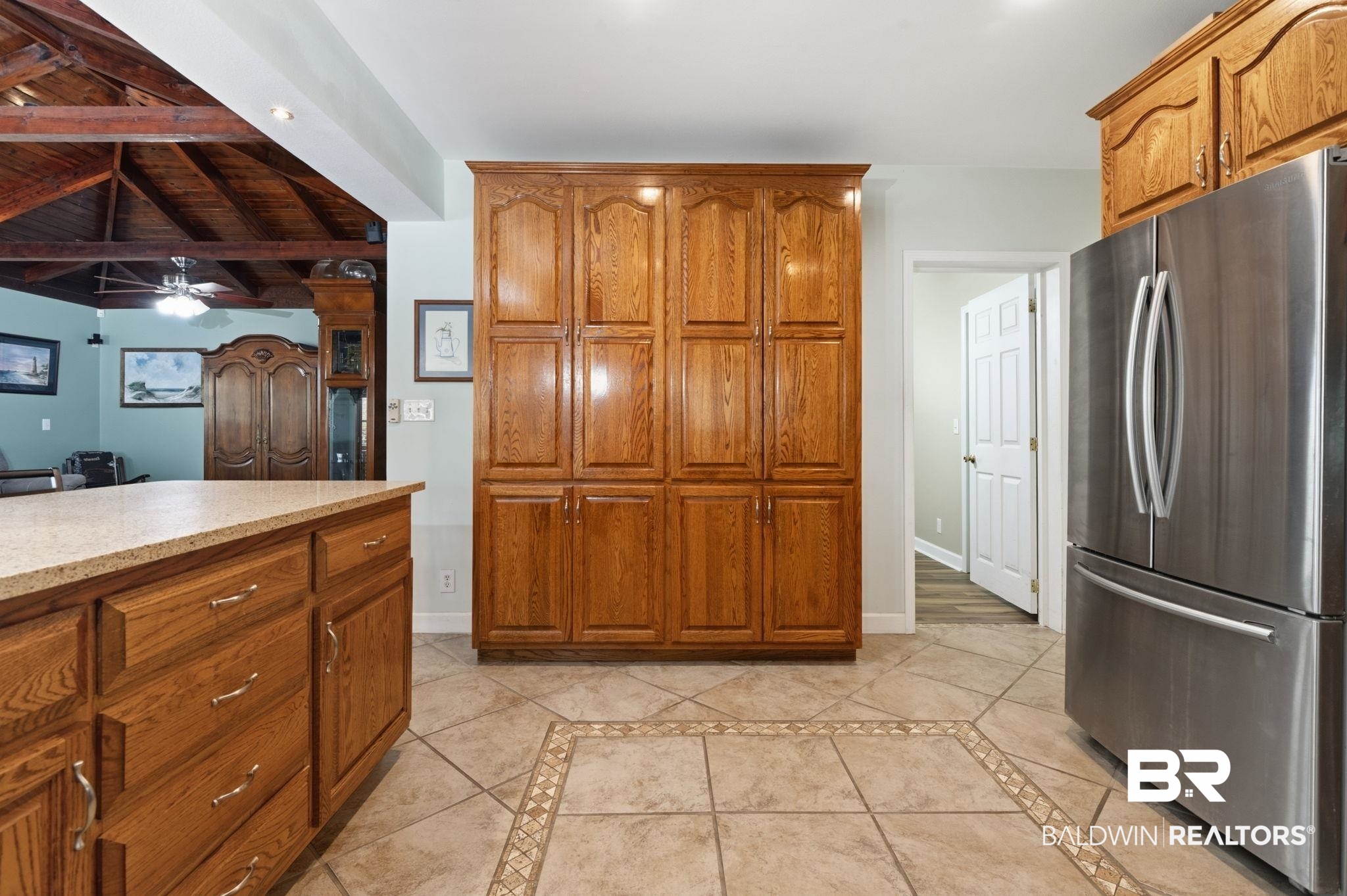 15025 Bellingrath Road Coden, AL 36523 - Photo 46 of 79 Kitchen featuring freestanding refrigerator, inlaid floor details, wood finish cabinets, lofted ceiling with beams, and wood ceiling