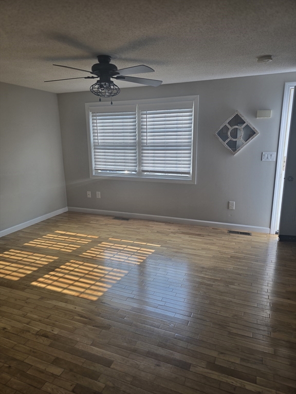 89 Belanger Street, Unit 89 Three Rivers, MA 01080 - Photo 1 of 19 a view of empty room with wooden floor and fan