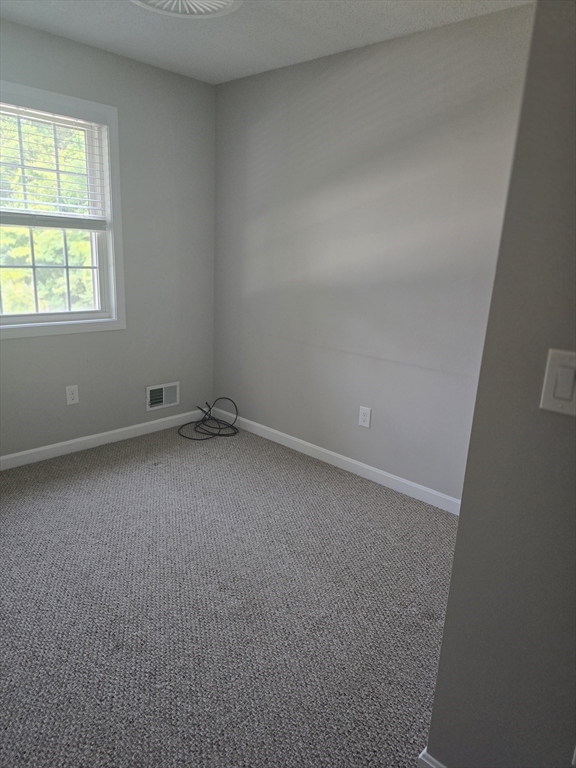 89 Belanger Street, Unit 89 Three Rivers, MA 01080 - Photo 11 of 19 an empty room with a window