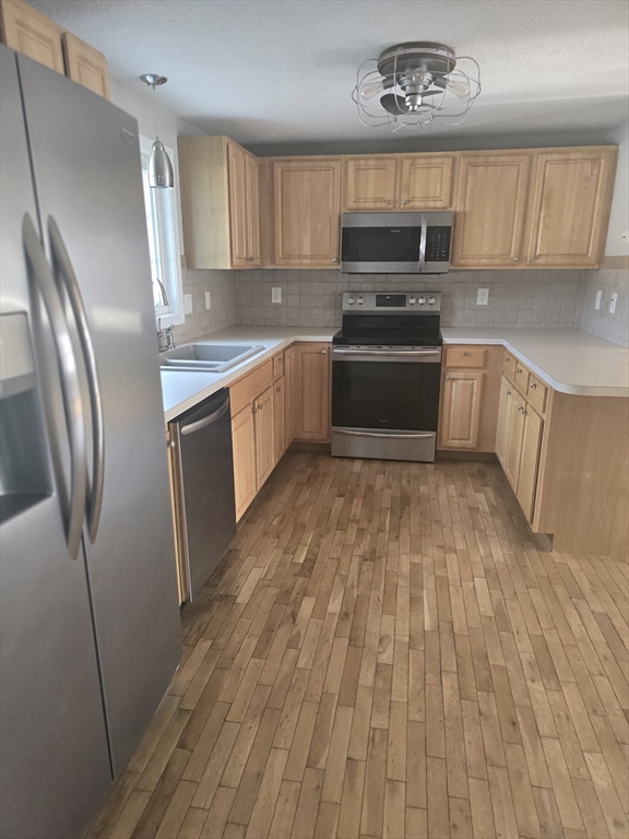 89 Belanger Street, Unit 89 Three Rivers, MA 01080 - Photo 5 of 19 a kitchen with wooden cabinets and stainless steel appliances