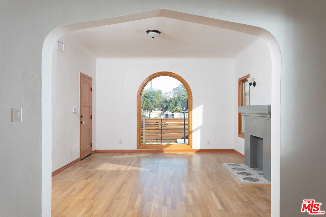 3009 Virginia Road Los Angeles, CA 90016 - Photo 3 of 8 a view of empty room with wooden floor and fireplace
