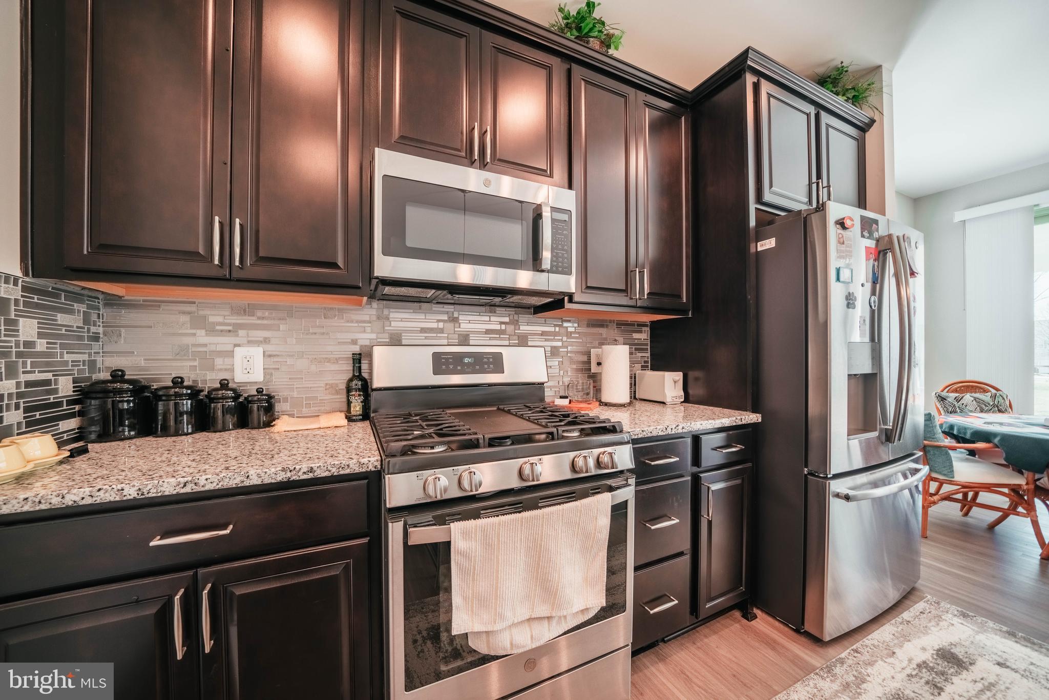 2175 Juniper Drive Culpeper, VA 22701 - Photo 3 of 34 a kitchen with granite countertop stainless steel appliances and wooden cabinets
