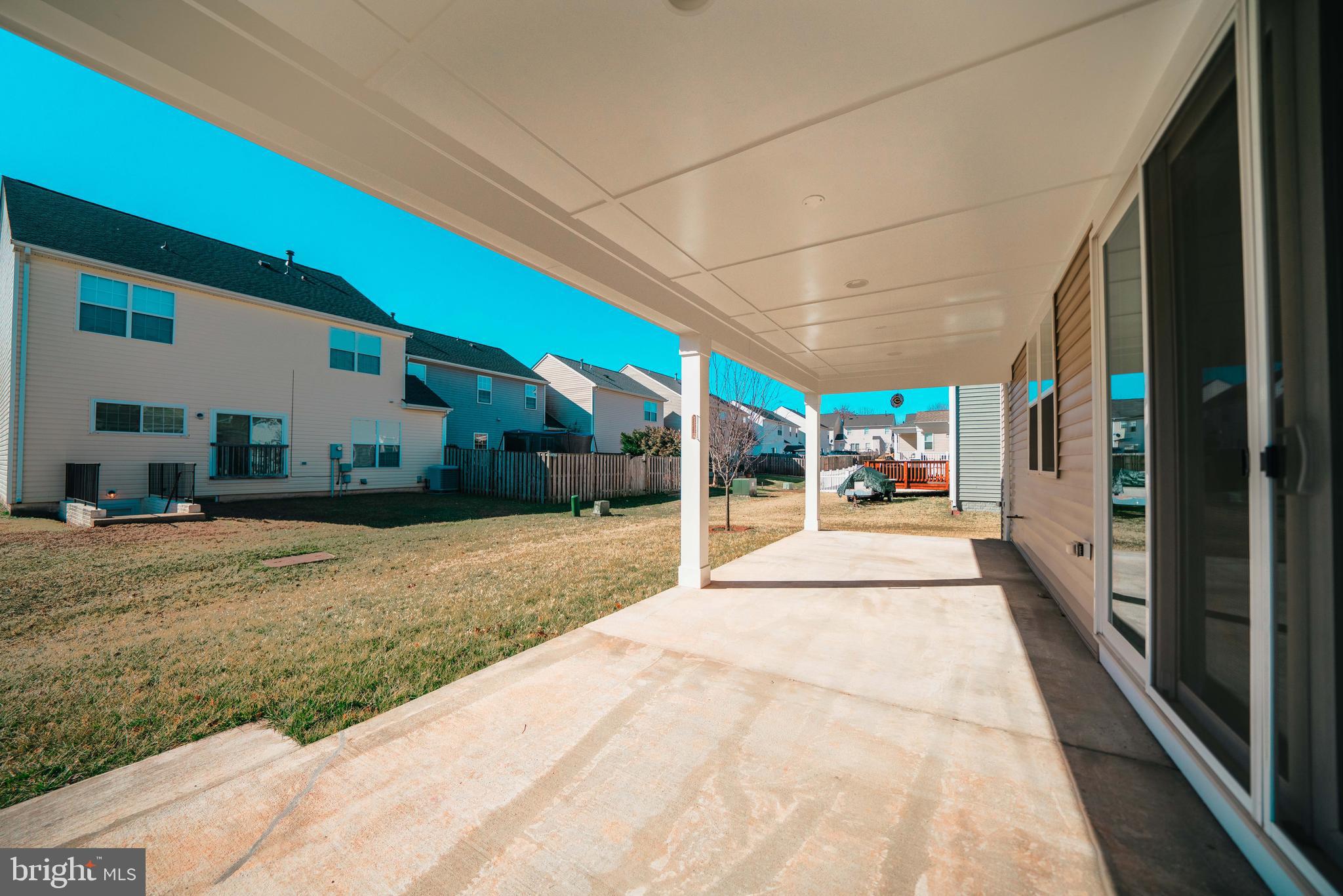 2175 Juniper Drive Culpeper, VA 22701 - Photo 31 of 34 a view of a patio with table and chairs potted plants with floor to ceiling window
