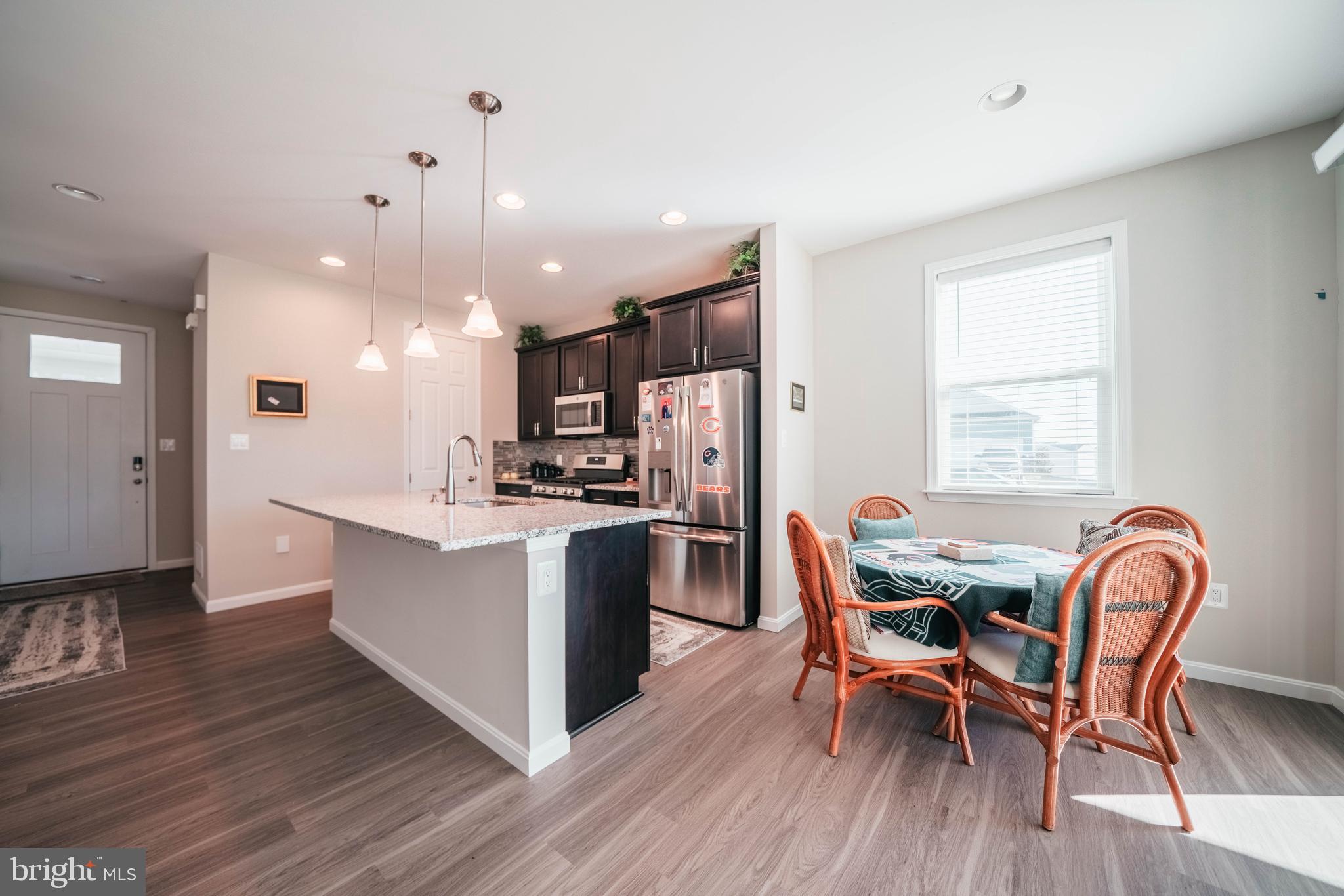 2175 Juniper Drive Culpeper, VA 22701 - Photo 5 of 34 a kitchen with stainless steel appliances kitchen island granite countertop wooden floor and dining table