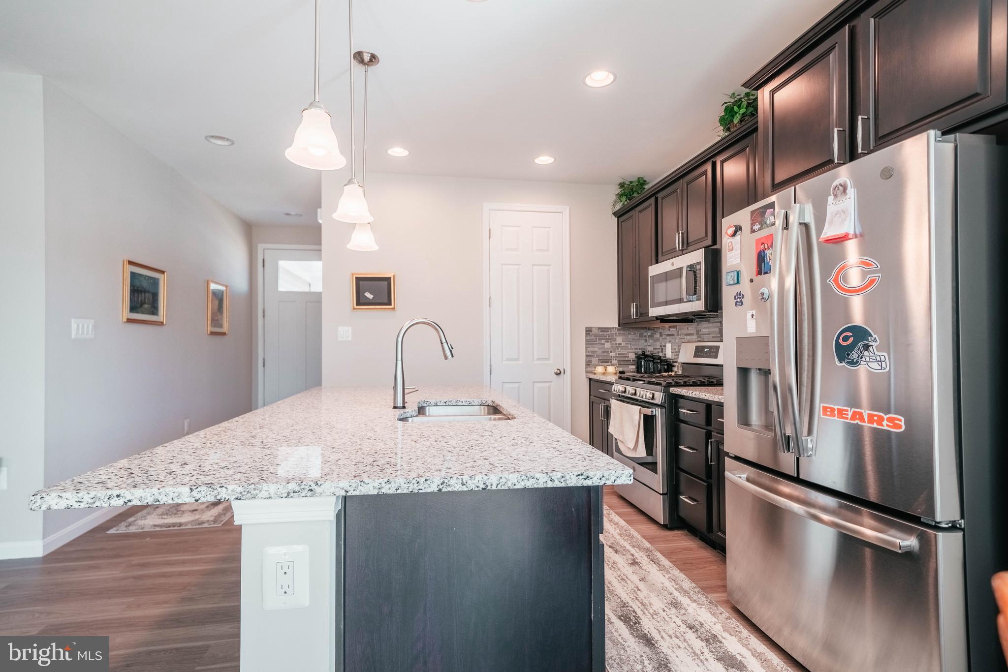 2175 Juniper Drive Culpeper, VA 22701 - Photo 8 of 34 a kitchen with stainless steel appliances granite countertop a refrigerator a sink and a stove