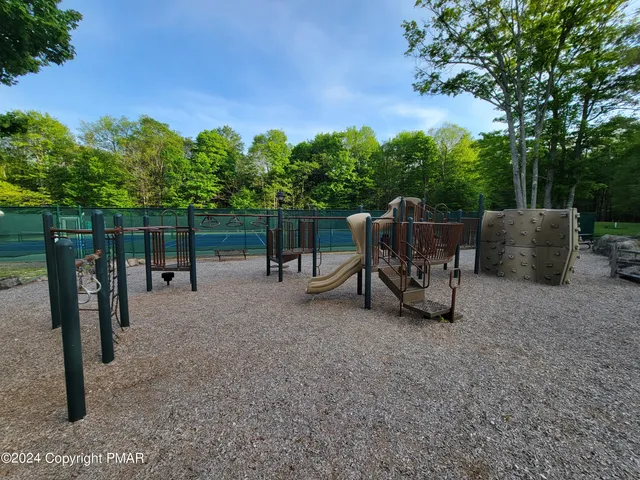 a view of a chairs and table in the backyard