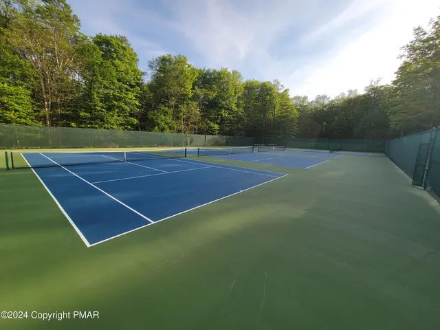 a view of an outdoor space and basketball court