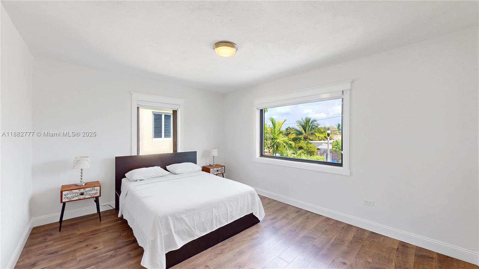 702 86th Street Miami Beach, FL 33141 - Photo 11 of 25 a bedroom with a bed and a window