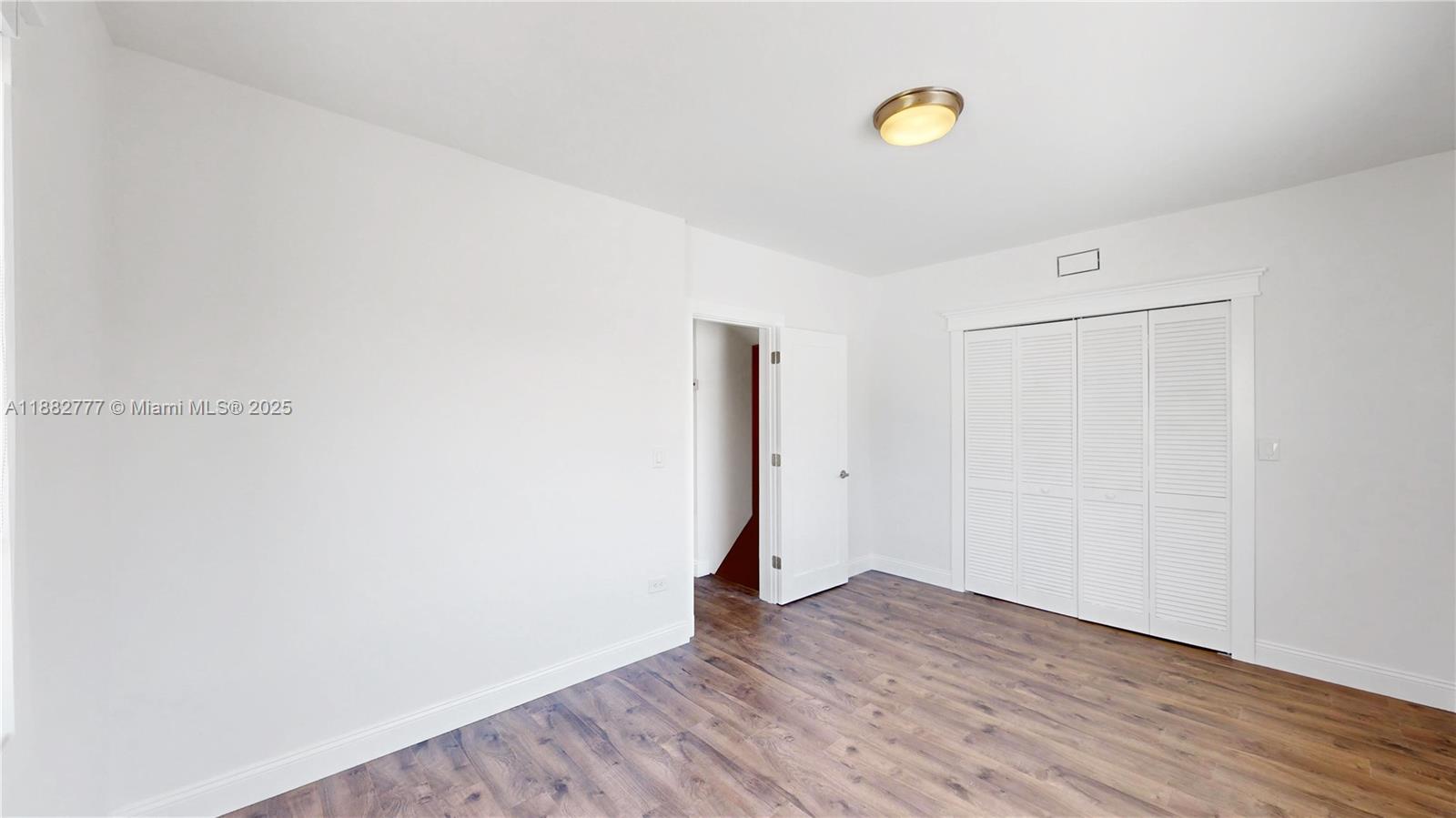 702 86th Street Miami Beach, FL 33141 - Photo 14 of 25 a view of a room with wooden floor and window