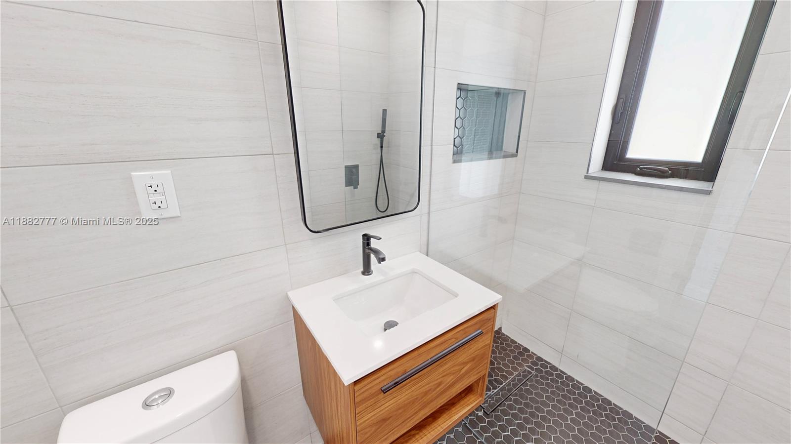 702 86th Street Miami Beach, FL 33141 - Photo 15 of 25 a bathroom with a sink and a mirror