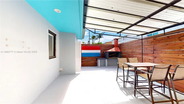 a view of a room with table and chairs