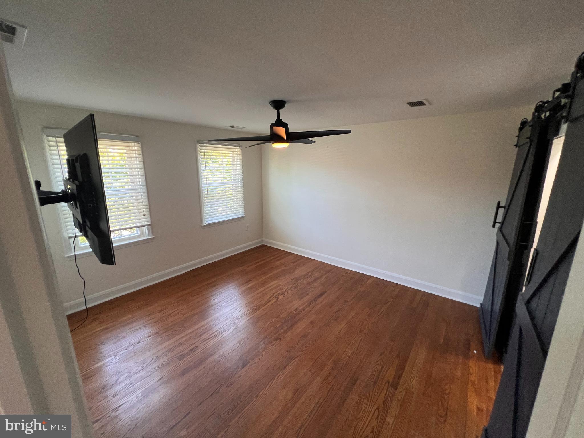 1583 Doxbury Road Towson, MD 21286 - Photo 13 of 31 an empty room with wooden floor and windows