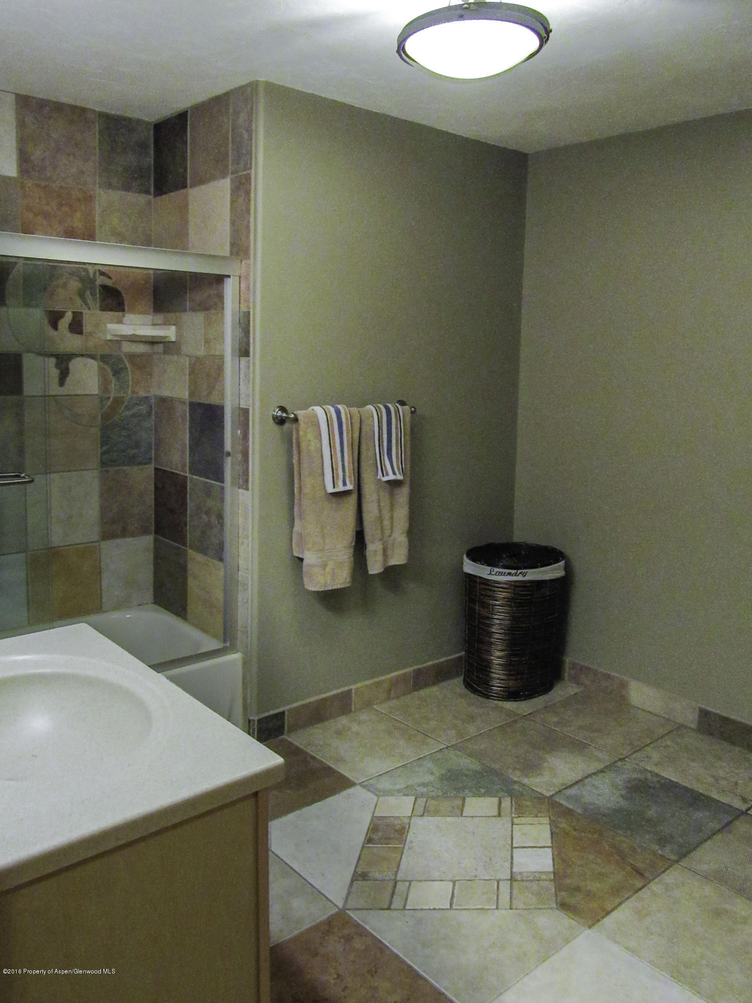 660 Moki Avenue Rifle, CO 81650 - Photo 12 of 25 a bathroom with a sink and a mirror