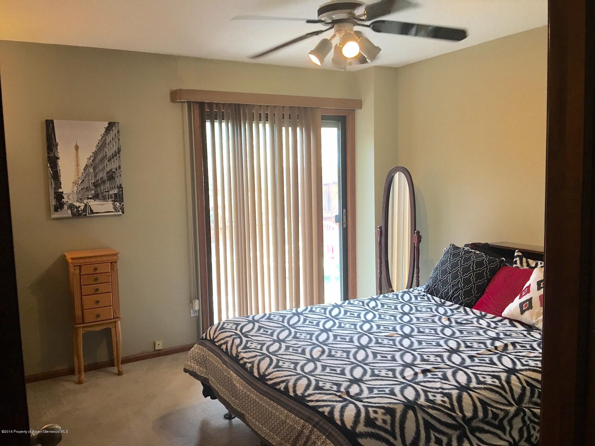 660 Moki Avenue Rifle, CO 81650 - Photo 14 of 25 a bedroom with a bed and a window