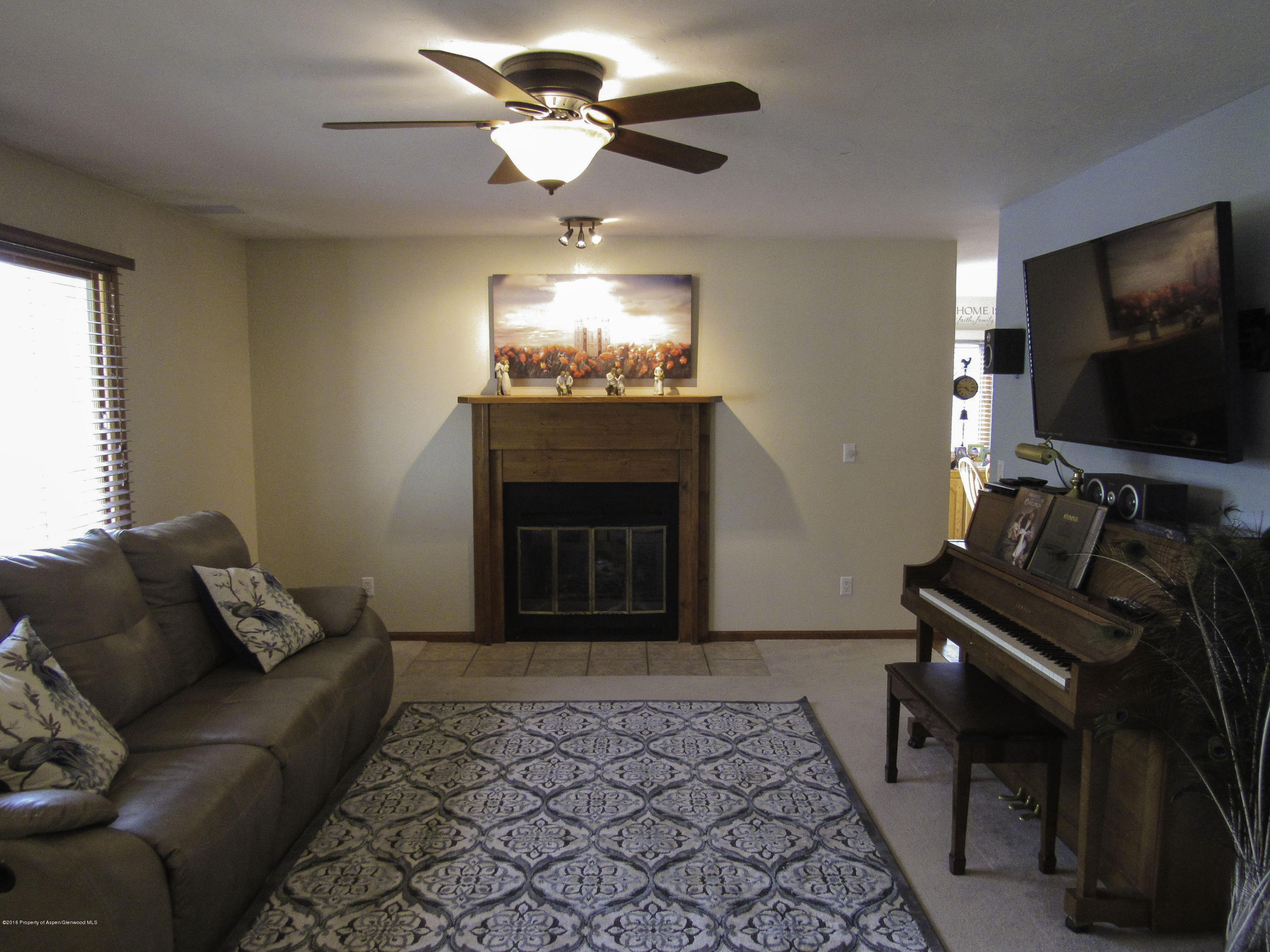 660 Moki Avenue Rifle, CO 81650 - Photo 6 of 25 a living room with furniture and a flat screen tv