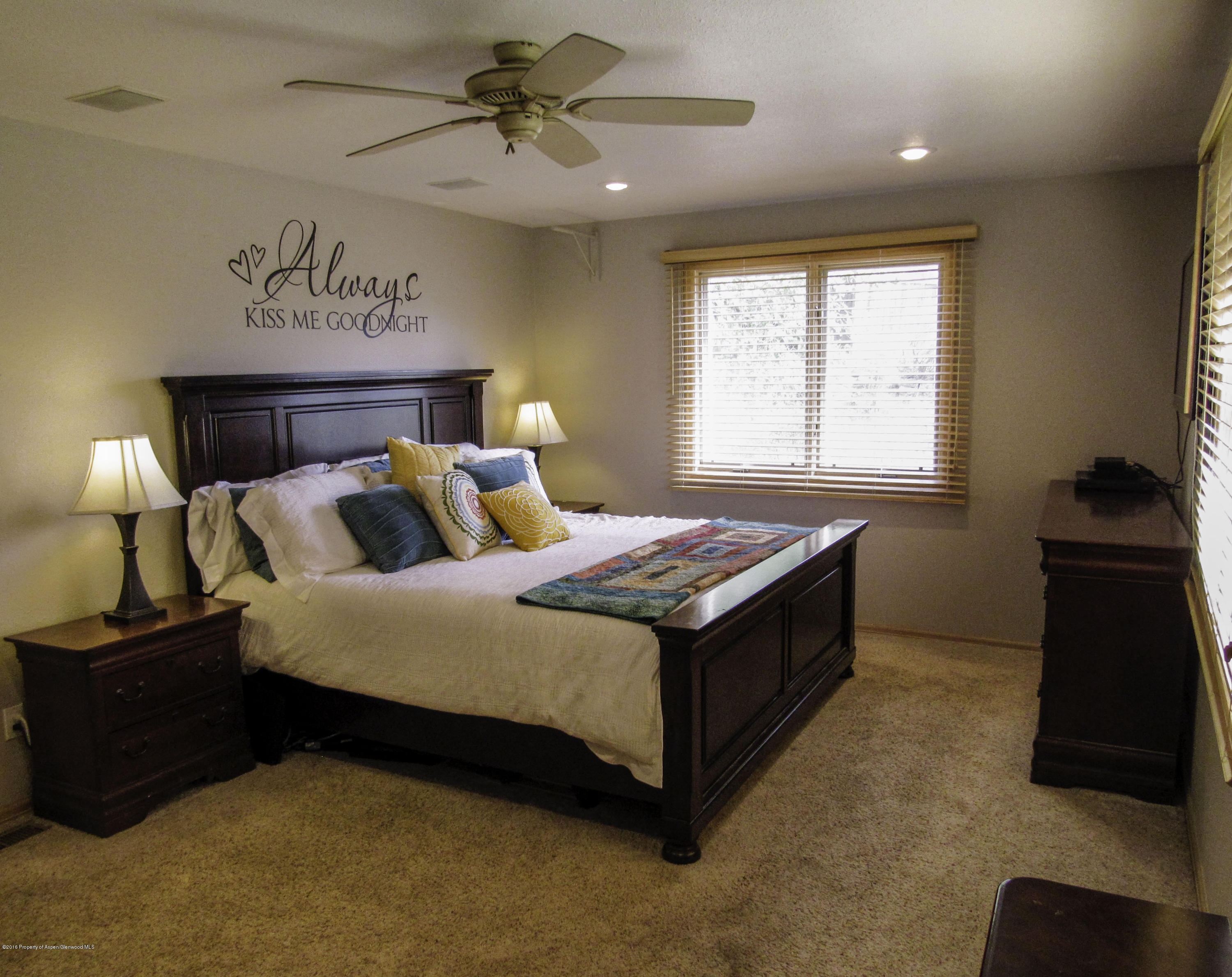 660 Moki Avenue Rifle, CO 81650 - Photo 8 of 25 a spacious bedroom with a bed and a ceiling fan