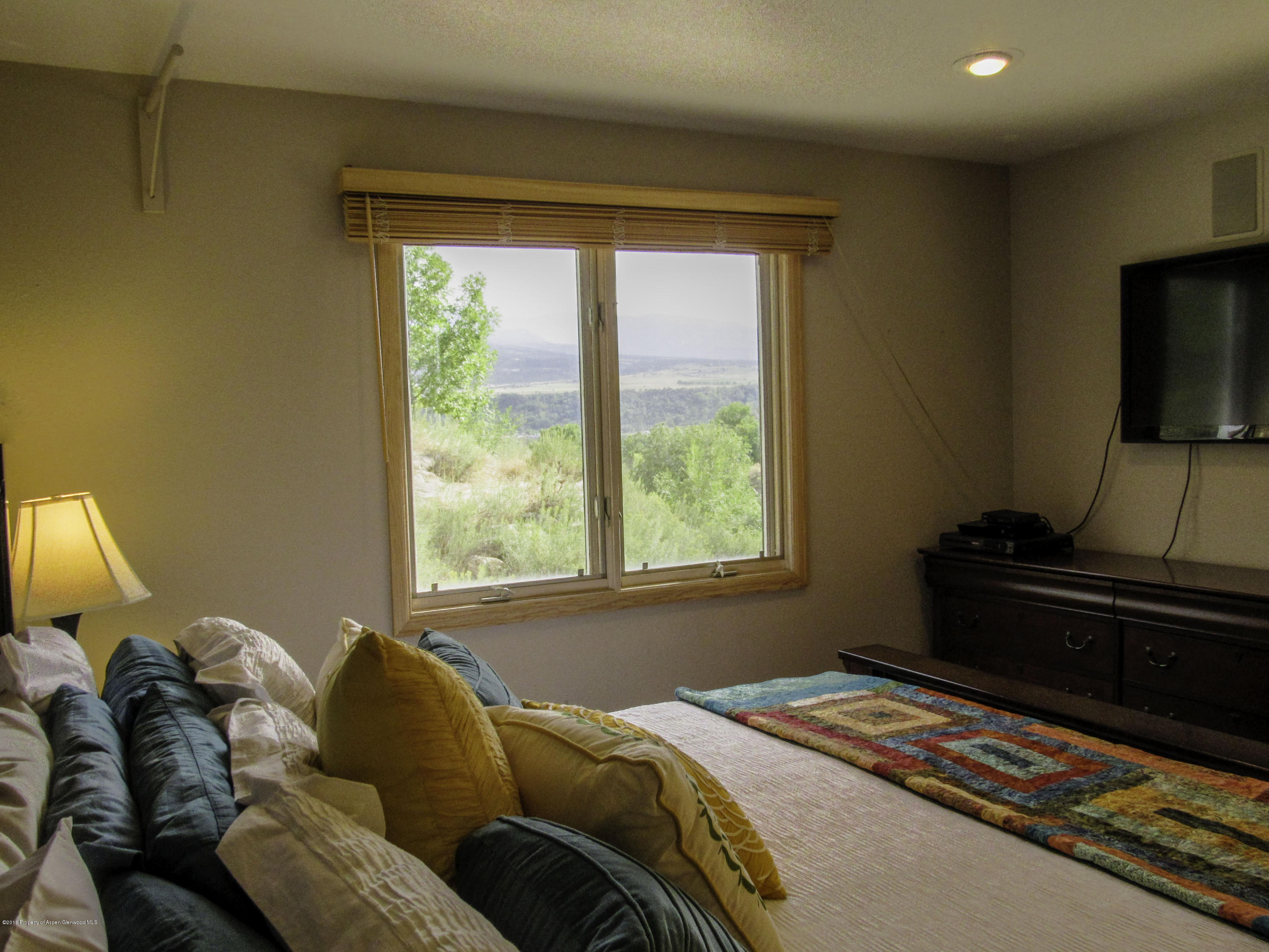 660 Moki Avenue Rifle, CO 81650 - Photo 9 of 25 a bed sitting in a bedroom next to a window