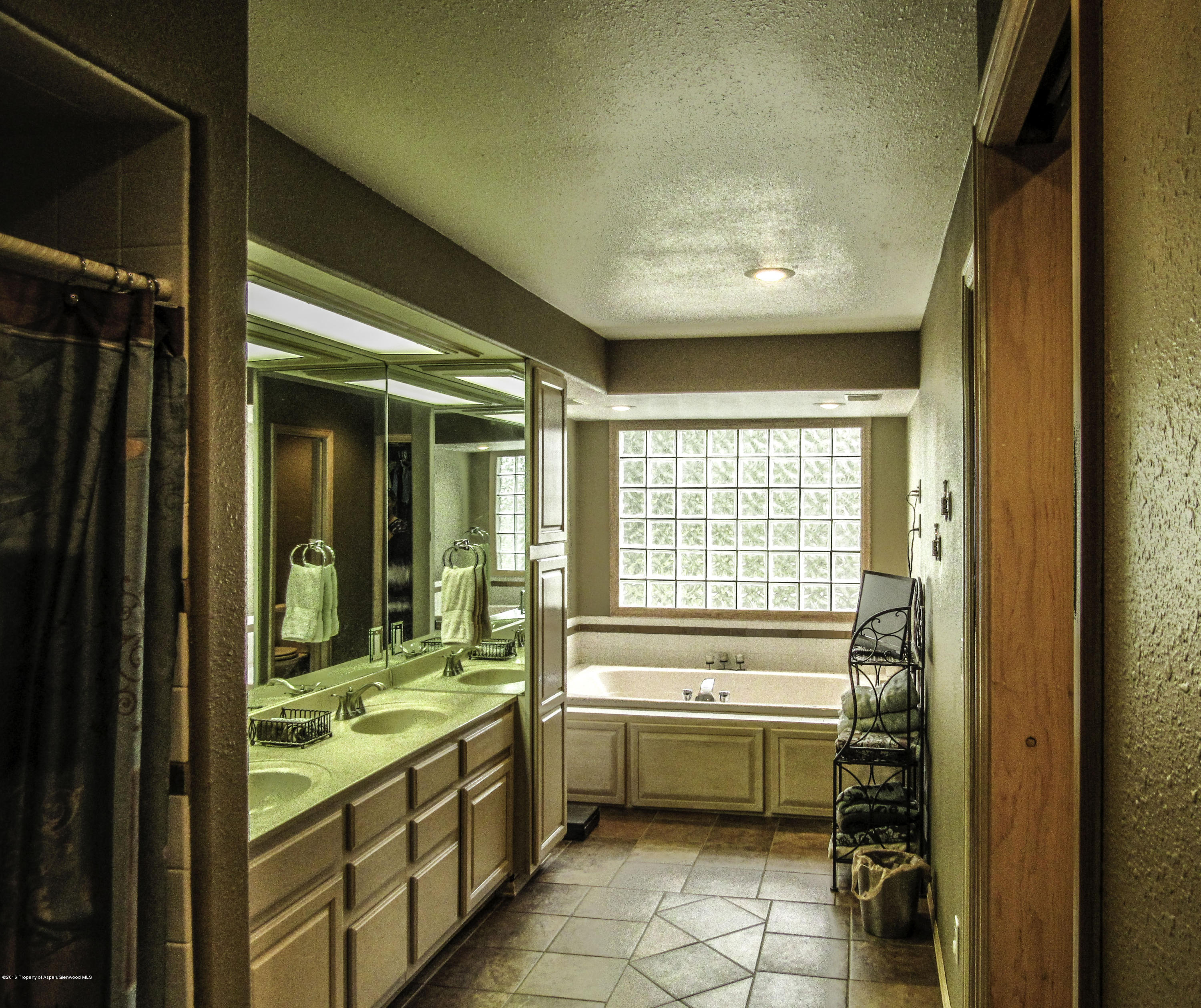 660 Moki Avenue Rifle, CO 81650 - Photo 10 of 25 a bathroom with a granite countertop sink a toilet and a bathtub